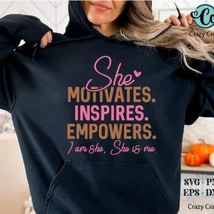 May include: Black hoodie with the text "She motivates. Inspires. Empowers. I am She, She is me." in pink and brown lettering.