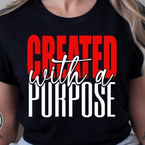 Puede incluir: Camiseta negra con las palabras "CREATED" en letras rojas, "with a" en escritura blanca y "PURPOSE" en letras blancas. El logotipo de Crazy Craft es visible en la esquina inferior izquierda.