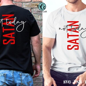 May include: Two t-shirts with the text "SATAN not today" printed on them. The text is in red and black. The shirts are white and black.