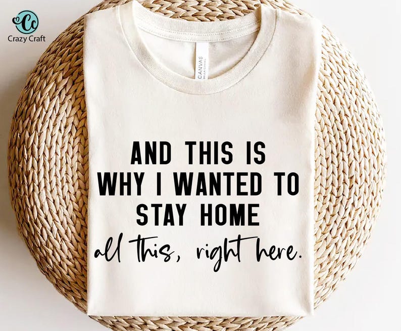 May include: White t-shirt with black text that reads "AND THIS IS WHY I WANTED TO STAY HOME all this, right here."