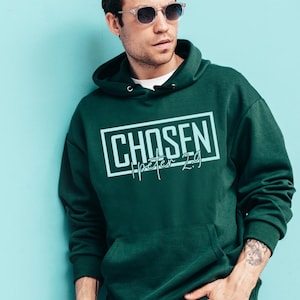 May include: A dark green hooded sweatshirt with the text "CHOSEN 1 Peter 2:9" in a light blue color.