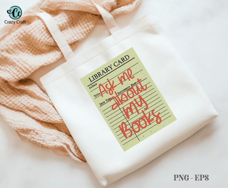 May include: White tote bag with cream-colored handles featuring a library card design. The card reads "Ask me about my books" in red script. The bag is on a beige textured surface.