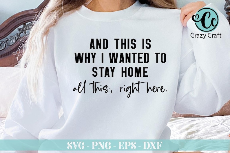 May include: White sweatshirt with black text that reads "AND THIS IS WHY I WANTED TO STAY HOME all this, right here."  The text is centered on the sweatshirt.  The sweatshirt is on a bed with a white blanket.