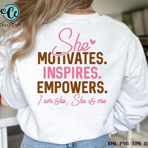 May include: White sweatshirt with a pink and brown graphic that says "She motivates. Inspires. Empowers. I am She, She is me."