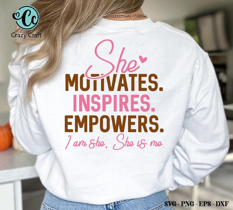 May include: White sweatshirt with a pink and brown graphic that says "She motivates. Inspires. Empowers. I am She, She is me."