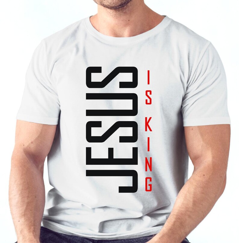 May include: White t-shirt with black text that reads "JESUS IS KING" in a vertical format.