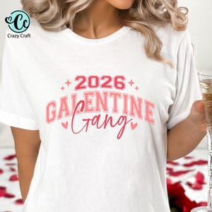 May include: White t-shirt with the text "2026 Galentine Gang" in pink and red lettering. The design includes hearts and stars. The Crazy Craft logo is in the upper left corner.
