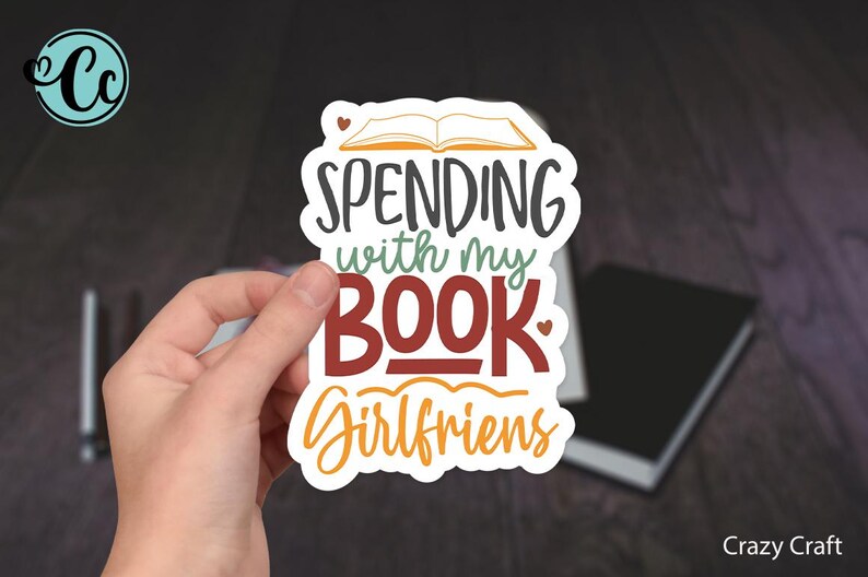 May include: White sticker with a book illustration and the text "Spending with my Book Girlfriends".