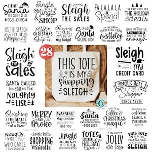 May include: A white tote bag with the text "THIS TOTE IS MY SHOPPING SLEIGH" in black. The image also features various Christmas-themed phrases and graphics, including "Dear Santa" and "Sleigh the Sales."