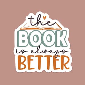 May include: A white sticker with a book illustration and the text "the book is always better" in black and orange lettering.