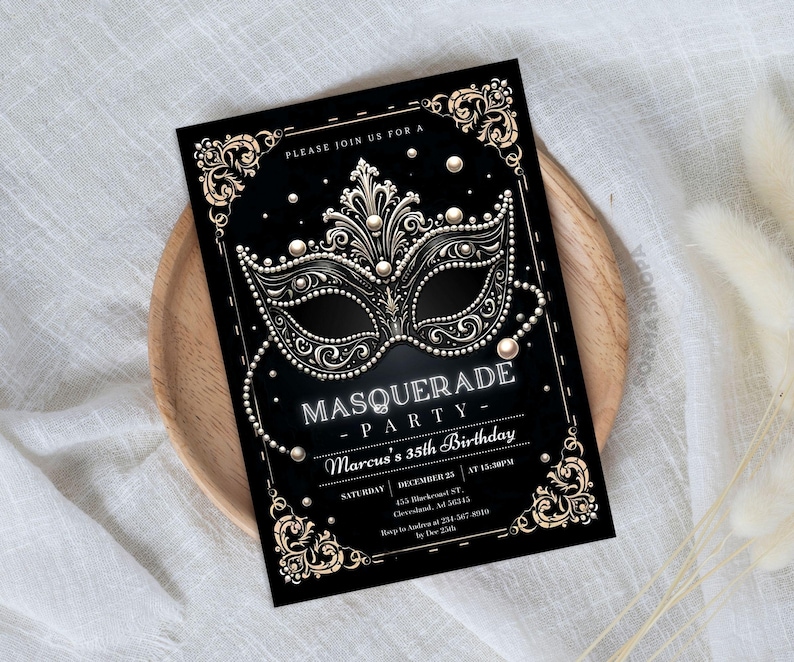 May include: A black rectangular invitation card featuring a central ornate masquerade mask graphic in gold and white. The text reads: PLEASE JOIN US FOR A MASQUERADE PARTY, Marcus's 35th Birthday, SATURDAY, DECEMBER 25, AT 10:30PM, 455 Blackcrest ST, Clevelend, AD 56345.