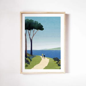 May include: A framed illustration of a blue body of water with a green grassy path leading to two people riding bicycles. A large green tree with a brown trunk is in the foreground. The sky is blue and the water is calm.