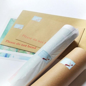 May include: A collection of travel posters, some rolled and some flat, with a diver graphic. The posters are packaged in brown envelopes and tubes, with the text "Please do not bend" printed on the envelopes.