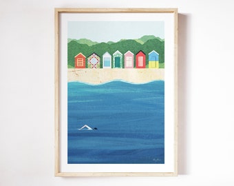 May include: A framed illustration of colorful beach houses on a sandy beach with a person swimming in the blue ocean. The houses are in a row and have different colors and patterns. The ocean is a deep blue and has white waves. The beach is a light brown color.