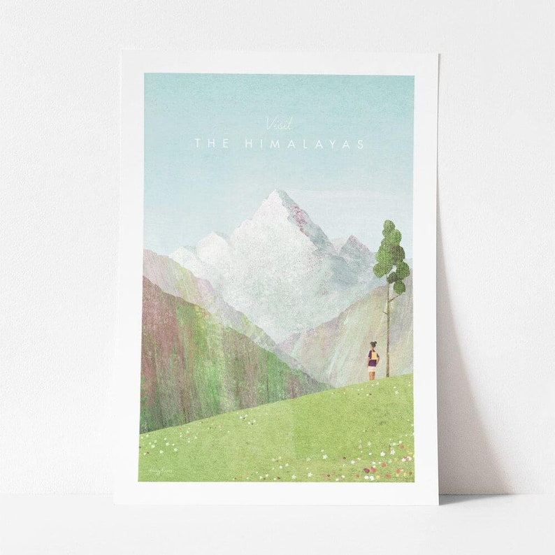 May include: A watercolour illustration of a mountain range with a person standing in the foreground. The mountains are snow-capped and the sky is blue. The text "Visit The Himalayas" is at the top of the image.