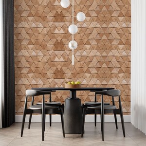 May include: A black dining table with six black chairs, set against a wall with a geometric wood-patterned wallpaper. A bowl of fruit sits on the table.