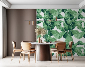 May include: A dining room with a wooden table and chairs, a modern light fixture, and a tropical leaf patterned wallpaper.