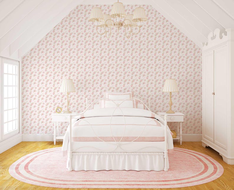 May include: A white metal bed frame with a white and pink bedding set. The bed is in a room with pink floral wallpaper and a white rug.