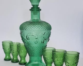 Mid Century Vintage 1970s Green Pressed Glass Decanter and set of 6 Shot Glasses with Embossed Floral Design.
