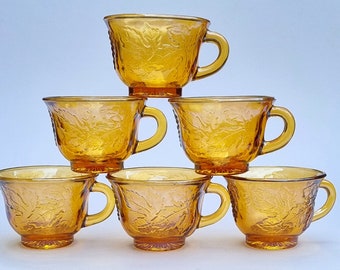 A Set of 6 Vintage 1970s Indiana Carnival Amber Glass Cups With Embossed Grapevine Leaves and a Bunch of Grapes.
