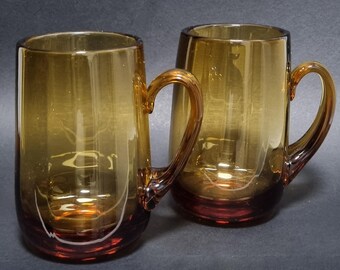 A Pair Modernist Mid Century Vintage 60s/70s Whitefriars Hand Blown Amber Glass with Double Fluted Handles Beer Tankards.