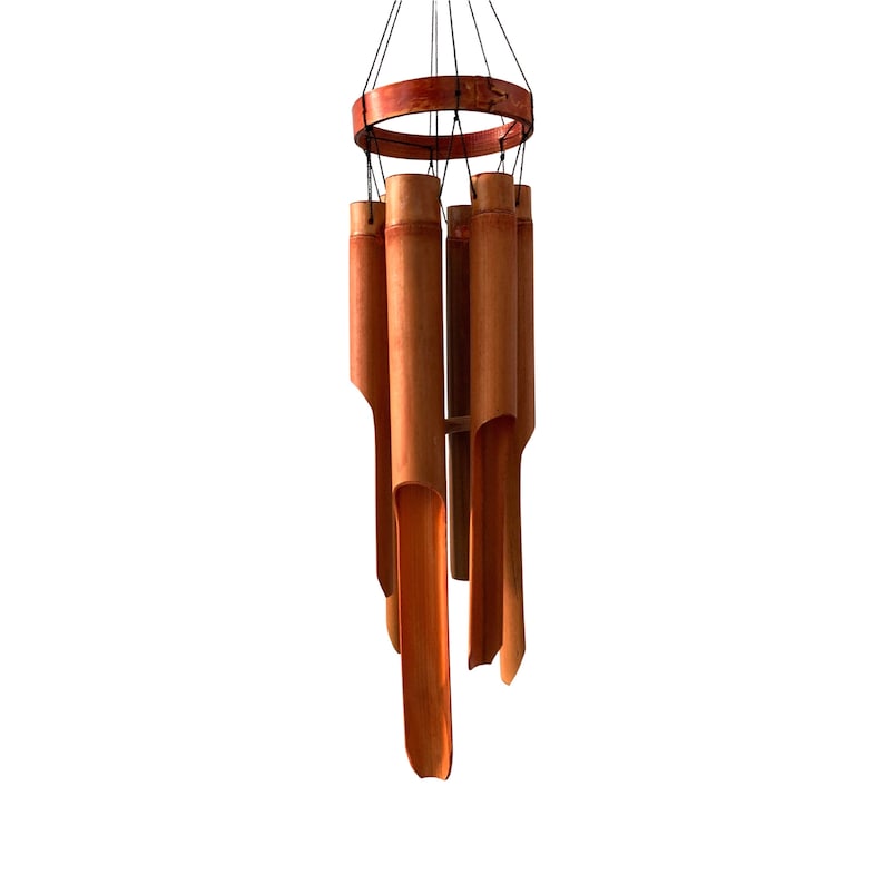 May include: A wooden wind chime with a circular top and multiple hollow bamboo tubes hanging from it. The tubes are a reddish-brown color.