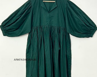 May include: A dark green dress with long, voluminous sleeves and a gathered waist. The dress has a V-neckline and hangs on a wooden hanger. The text "ARKFASHIONHUB" is visible on the lower left side of the dress.