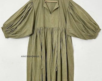 May include: Olive green dress with long, voluminous sleeves and a gathered waist. The dress has a V-neckline with a tie detail and falls to a midi length. The brand name "ARKFASHIONHUB" is printed on the dress. The dress is hanging on a wooden hanger.