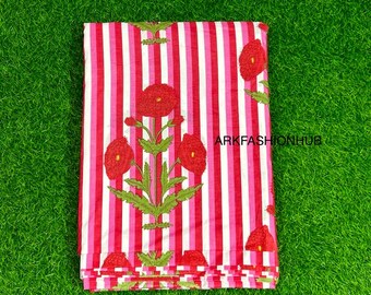 May include: Folded fabric with a striped pattern in red, pink, and white. The fabric is adorned with embroidered red flowers and green leaves. The text "ARKFASHIONHUB" is visible on the fabric.