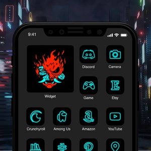 May include: A black smartphone screen displaying a grid of app icons with neon blue and red outlines. The icons include Discord, Camera, Game, Etsy, Crunchyroll, Among Us, Amazon, YouTube, and more. The time on the screen is 9:41.