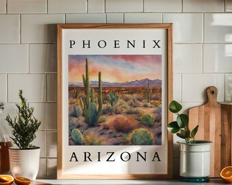 Puede incluir: Una pintura acuarela enmarcada de un paisaje desértico con el texto "PHOENIX ARIZONA" en la parte superior e inferior. La pintura representa una puesta de sol sobre un campo de cactus y montañas en la distancia.