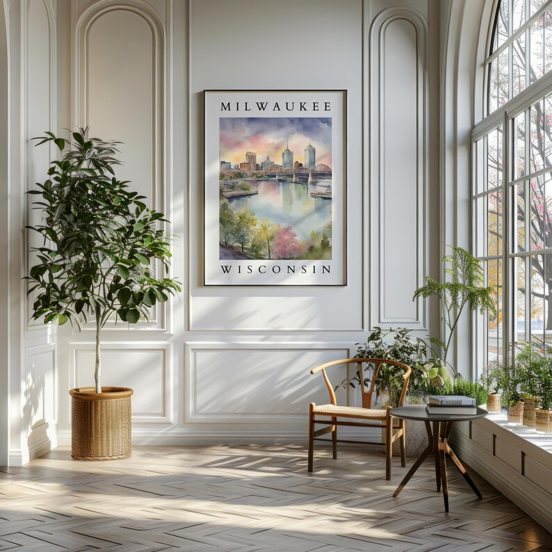 A Milwaukee watercolor print hanging in a grand room with tall windows, soft lighting, and lush green plants, creating an airy and inviting atmosphere.