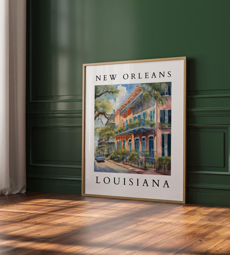 May include: A watercolor painting of a street scene in New Orleans, Louisiana. The painting features colorful buildings with balconies and lush greenery. The text "NEW ORLEANS" and "LOUISIANA" is printed at the top and bottom of the painting.