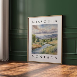 May include: A framed watercolor painting of a river winding through a valley with mountains in the background. The text "MISSOULA MONTANA" is printed below the image.