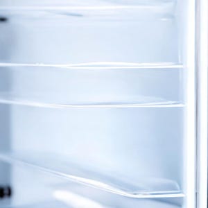 May include: Empty white refrigerator interior with multiple glass shelves.