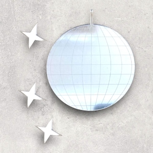 May include: A silver disco ball with a mirrored surface and a grid pattern. Three white star-shaped decorations are placed around the disco ball.
