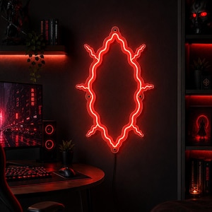 May include: A bright red neon light fixture shaped like an elongated, wavy-edged oval with small lightning-like protrusions extending from the sides. The light is mounted on a dark wall and features a visible black power cord extending from the bottom.