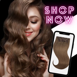 May include: A woman with long, wavy brown hair smiles, with a phone displaying brown hair extensions. The words "SHOP NOW" are in pink neon. The background is black and white.