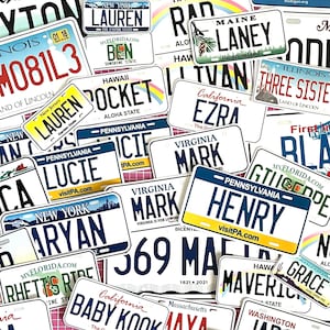May include: A collage of license plate stickers, each displaying a name and a state. Names such as "Lauren", "Henry", and "Baby Kook" are visible, alongside states like "New York", "Hawaii", and "California".