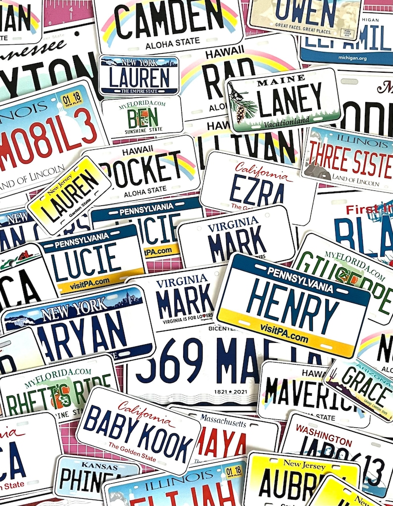 May include: A collection of colorful license plate stickers with various names and state names. The stickers feature names like "Lauren", "Henry", and "Baby Kook", with states including "New York", "Hawaii", and "California".
