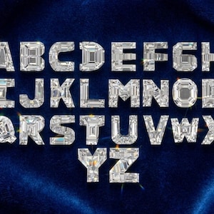 May include: A full alphabet of sparkling, diamond-like letters, each with a faceted design, is displayed against a deep blue velvet background. The letters are arranged in a standard alphabetical order, creating a luxurious and eye-catching visual.