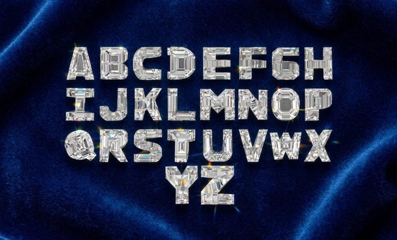 May include: A full alphabet of sparkling, diamond-like letters, each with a faceted design, is displayed against a deep blue velvet background. The letters are arranged in a standard alphabetical order, creating a luxurious and eye-catching visual.