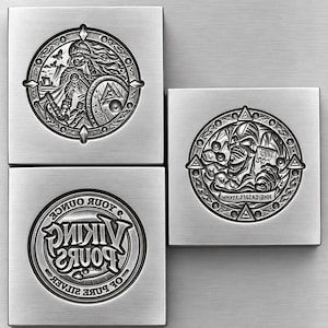 May include: Three square silver-toned metal plates featuring embossed circular designs. One plate shows a Viking warrior, another a skull-like figure with text, and the third displays the text VIKING BONES OF THE LAKE. The finish is brushed metal.