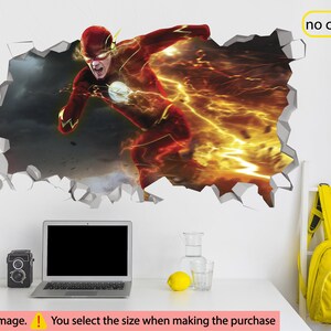 May include: A 3D wall decal featuring The Flash, a superhero running through a cracked wall with lightning bolts. The decal is printed on a white background.