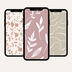 May include: Three different phone wallpapers displayed on black iPhone mockups. The first wallpaper is a white background with brown abstract shapes. The second wallpaper is a pink background with white leaves and yellow dots. The third wallpaper is a light brown background with white abstract lines.