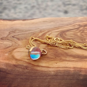 Light reflecting mermaid glass bead on 16” gold chain necklace
