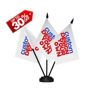 May include: Three white desk flags with black poles and a black base. Each flag has the text "custom design your own" in red and blue lettering.