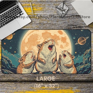 May include: Large mousepad featuring three cartoon hamsters singing in front of a full moon and a starry sky with planets. The mousepad is 16 inches by 32 inches and has the word "LARGE" printed on it.