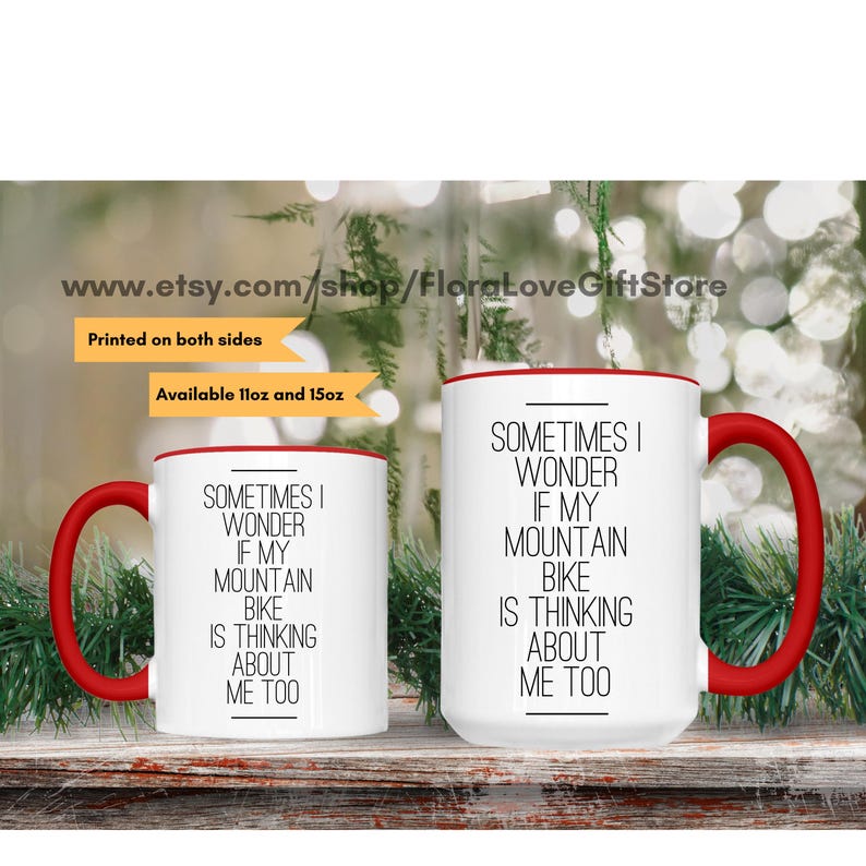 May include: Two white ceramic mugs with red rims. The mugs have a black text design that reads "Sometimes I wonder if my mountain bike is thinking about me too".