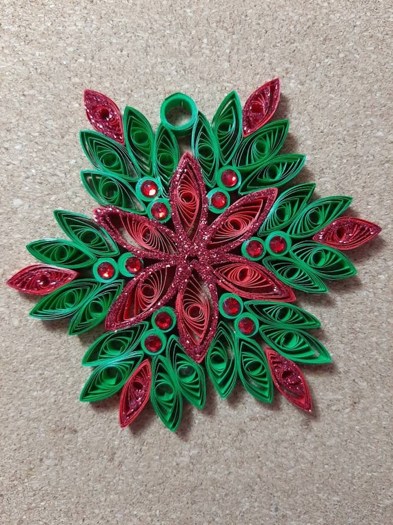 Quilled snowflake on red ornament